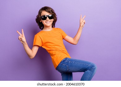 Portrait of attractive cheerful boy showing v-sign dancing having fun isolated over violet purple color background - Powered by Shutterstock