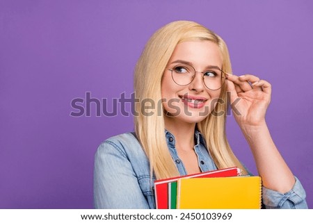 Portrait of attractive cheerful brainy girl deciding copy space isolated over bright violet purple color background