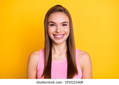 Portrait of attractive cheerful brown-haired girl wearing pink tanktop nice look isolated over bright yellow color background