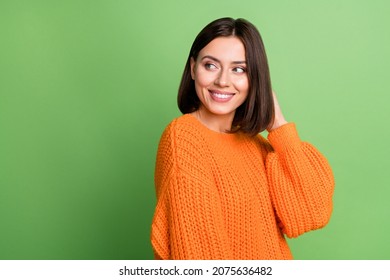 Portrait of attractive cheerful brown-haired girl looking aside copy space isolated over vivid green color background