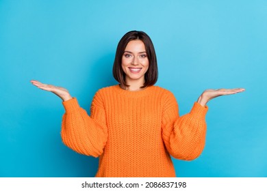 Portrait of attractive cheerful brown-haired girl holding on palms copy space ad isolated over bright blue color background - Shutterstock ID 2086837198