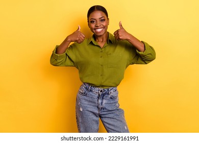 Portrait of attractive cheerful brunette girl showing double thumbup perfect ad isolated over bright yellow color background - Powered by Shutterstock