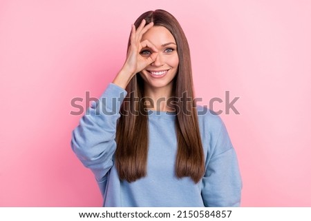 Portrait of attractive cheerful brunette girl showing ok-sign look see isolated over pink pastel color background