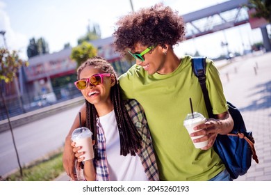 Portrait of attractive cheerful carefree couple spending free time sunny day drinking takeout latte having fun outdoors - Powered by Shutterstock