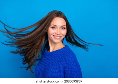 Portrait of attractive cheerful carefree girl throwing healthy smooth hair motion isolated over vibrant blue color background