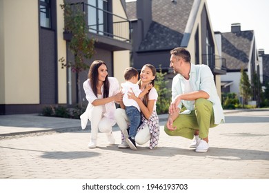 Portrait of attractive cheerful careful family having fun mom dad playing with kids spending free time fresh air outdoor