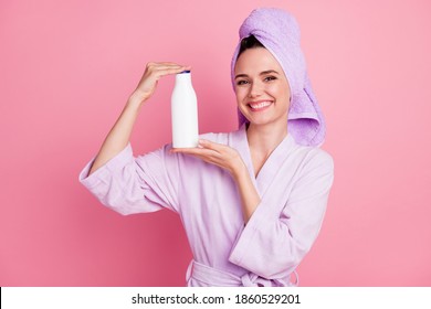 Portrait Of Attractive Cheerful Cheery Girl Wearing Turban Holding In Hands Keratin Shampoo Haircare Isolated On Pink Pastel Color Background