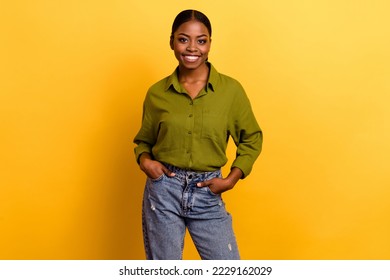 Portrait of attractive cheerful content brunette girl posing holding hands in pockets isolated over bright yellow color background - Powered by Shutterstock