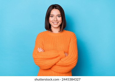 Portrait of attractive cheerful content girl folded arms wearing warm wool jumper isolated over bright blue color background. - Powered by Shutterstock