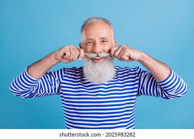 Portrait of attractive cheerful content grey-haired man touching mustache fixing isolated over bright blue color background