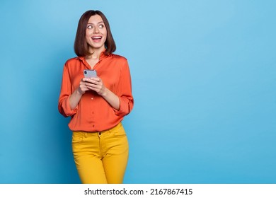 Portrait of attractive cheerful curious girl using device copy space media news like isolated over bright blue color background