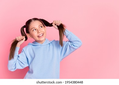 Portrait Of Attractive Cheerful Curious Preteen Girl Making Tails Having Fun Copy Space Isolated Over Pink Pastel Color Background