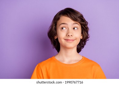 Portrait of attractive cheerful cute curious boy looking aside thinking copy space isolated over violet purple color background - Powered by Shutterstock