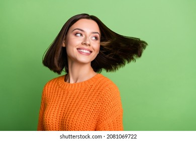 Portrait of attractive cheerful dreamy girl throwing hair enjoying dream isolated over bright green color background