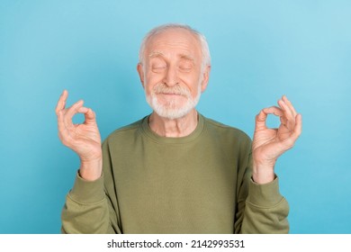 Portrait of attractive cheerful funny grey-haired man meditating free time isolated over bright blue color background - Powered by Shutterstock