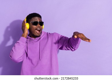 Portrait of attractive cheerful funny guy listening bass soul jazz having fun isolated over bright violet lilac color background
