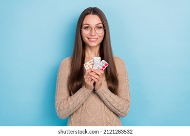 Portrait of attractive cheerful girl holding in hands meds anti virus pharmacy isolated over bright blue color background - Shutterstock ID 2121283532