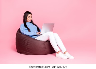 Portrait Of Attractive Cheerful Girl Sitting Using Laptop Writing Email Eshop Isolated Over Pink Pastel Color Background