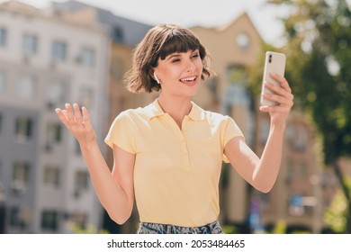 Portrait of attractive cheerful girl talking on video call roaming using device spending free time on fresh air outdoors - Powered by Shutterstock