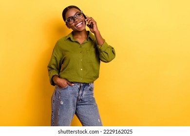 Portrait of attractive cheerful girl using gadget calling friend talking isolated over bright yellow color background - Powered by Shutterstock