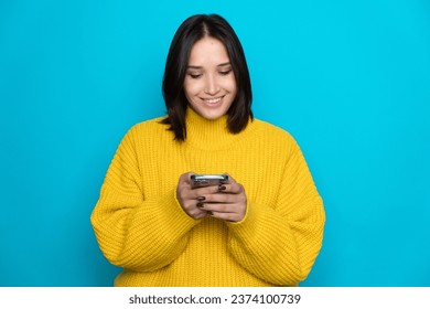 Portrait of attractive cheerful girl using device gadget app smm post isolated over bright blue color background. High quality photo - Shutterstock ID 2374100739