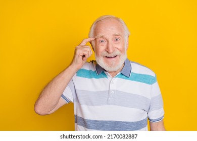 Portrait of attractive cheerful grey haired man touching temple making decision isolated over vivid yellow color background - Powered by Shutterstock