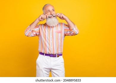 Portrait Of Attractive Cheerful Grey-haired Man Touching Mustache Thinking Isolated Over Bright Yellow Color Background