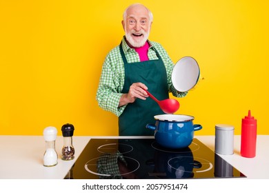 Portrait of attractive cheerful grey-haired man making meal recipe culinary workshop isolated over bright yellow color background - Powered by Shutterstock