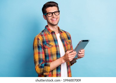 Portrait of attractive cheerful guy geek using device app 5g searching web isolated over bright blue color background - Shutterstock ID 1996007009