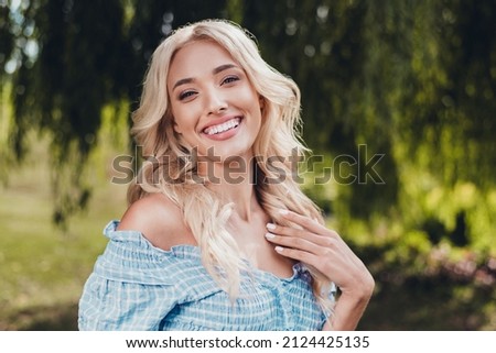 Image, Stock Photo A gorgeous blonde girl in a summer dress is having a relaxed afternoon. Her pretty long legs and beautiful face caption every main aspect of the image. A bit tired beauty on a hot summer day.