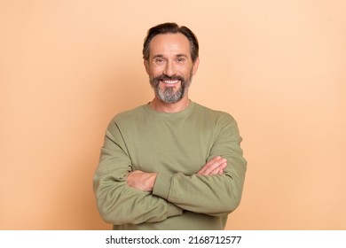 Portrait Of Attractive Cheerful Man Folded Arms Wearing Cozy Sweater Isolated Over Beige Pastel Color Background