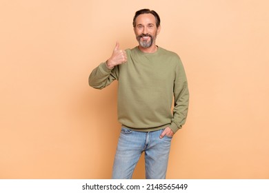 Portrait Of Attractive Cheerful Man Showing Thumbup Ad Cool Agree Isolated Over Beige Pastel Color Background