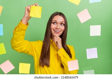 Portrait Of Attractive Cheerful Minded Girl Sticking Copy Space Memo Papers On Wall Isolated Over Green Pastel Color Background