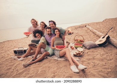 Portrait of attractive cheerful people gathering meeting eating water melon embracing free time at beach outdoors - Shutterstock ID 2090288890