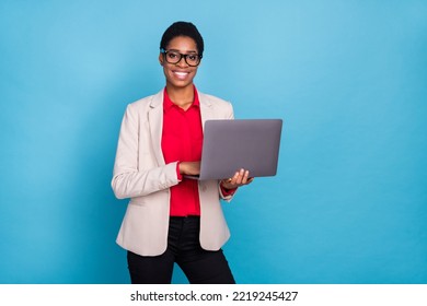 Portrait of attractive cheerful skilled expert developing web project using laptop isolated over bright blue color background - Powered by Shutterstock