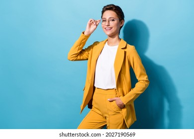 Portrait of attractive cheerful skilled woman expert posing touching specs isolated over bright blue color background