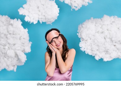Portrait of attractive cheerful sweet girl enjoying bedtime clouds flying isolated over bright blue color background - Shutterstock ID 2205769995