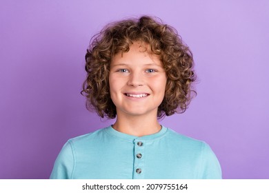 Portrait of attractive cheerful wavy-haired boy learner good mood isolated over bright violet purple color background
