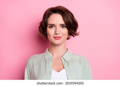 Portrait of attractive cheery content brown-haired girl employee wearing casual shirt isolated over pastel pink color background