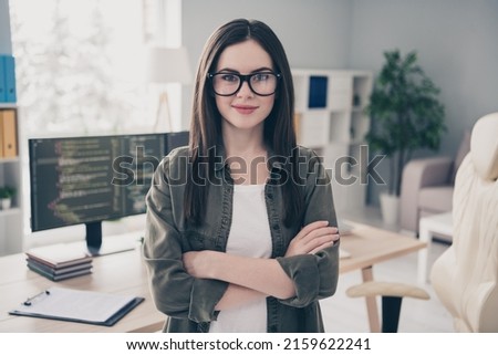 Portrait of attractive cheery content skilled girl expert folded arms at workplace workstation indoors