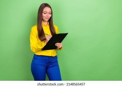 Portrait Of Attractive Cheery Focused Girl Employee Writing Plan Survey Copy Space Isolated Over Green Pastel Color Background