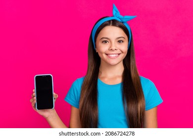 Portrait Of Attractive Cheery Long-haired Girl Demonstrating Gadget Isolated Over Shine Pink Magenta Color Background