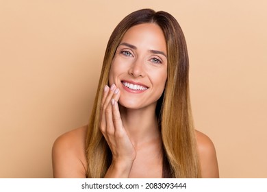 Portrait of attractive cheery long-haired woman touching soft flawless skin lifting uplift isolated over beige pastel color background