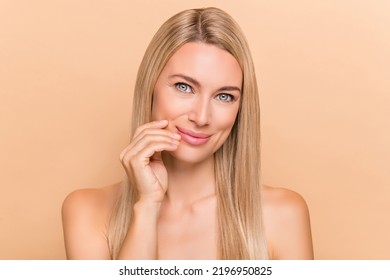 Portrait Of Attractive Cheery Nude Woman Touching Pure Smooth Skin Cc Cream Tonic Isolated Over Beige Pastel Color Background