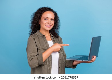Portrait of attractive cheery wavy-haired girl holding demonstrating laptop isolated over bright blue color background - Shutterstock ID 2061778559
