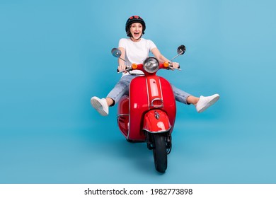 Portrait Of Attractive Comic Childish Cheerful Woman Riding Moped Having Fun Fooling Isolated Over Bright Blue Color Background