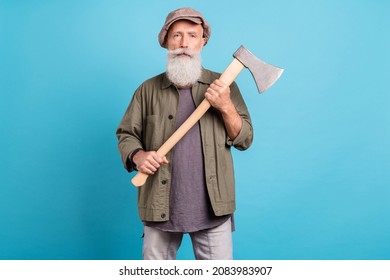 Portrait of attractive content funny grey-haired man mister holding sharp ax isolated over bright blue color background