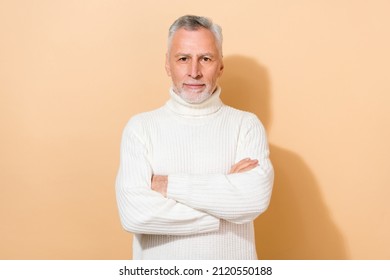 Portrait Of Attractive Content Grey-haired Man Folded Arms Wearing Warm Clothes Isolated Over Beige Pastel Color Background