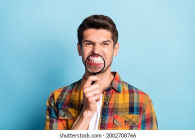 Portrait Of Attractive Crazy Funky Dangerous Guy Holding In Hand Enlarge Glass Evil Teeth Isolated Over Bright Blue Color Background