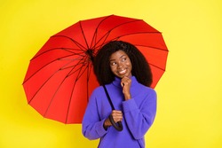 Portrait Of Attractive Dark Skin Lady Hand On Chin Look Empty Space Hold Umbrella Isolated On Yellow Color Background